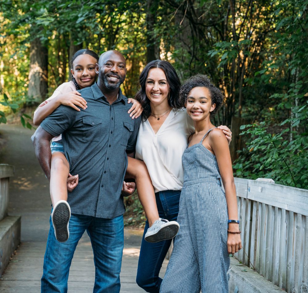 Happy family of four posing for a picture