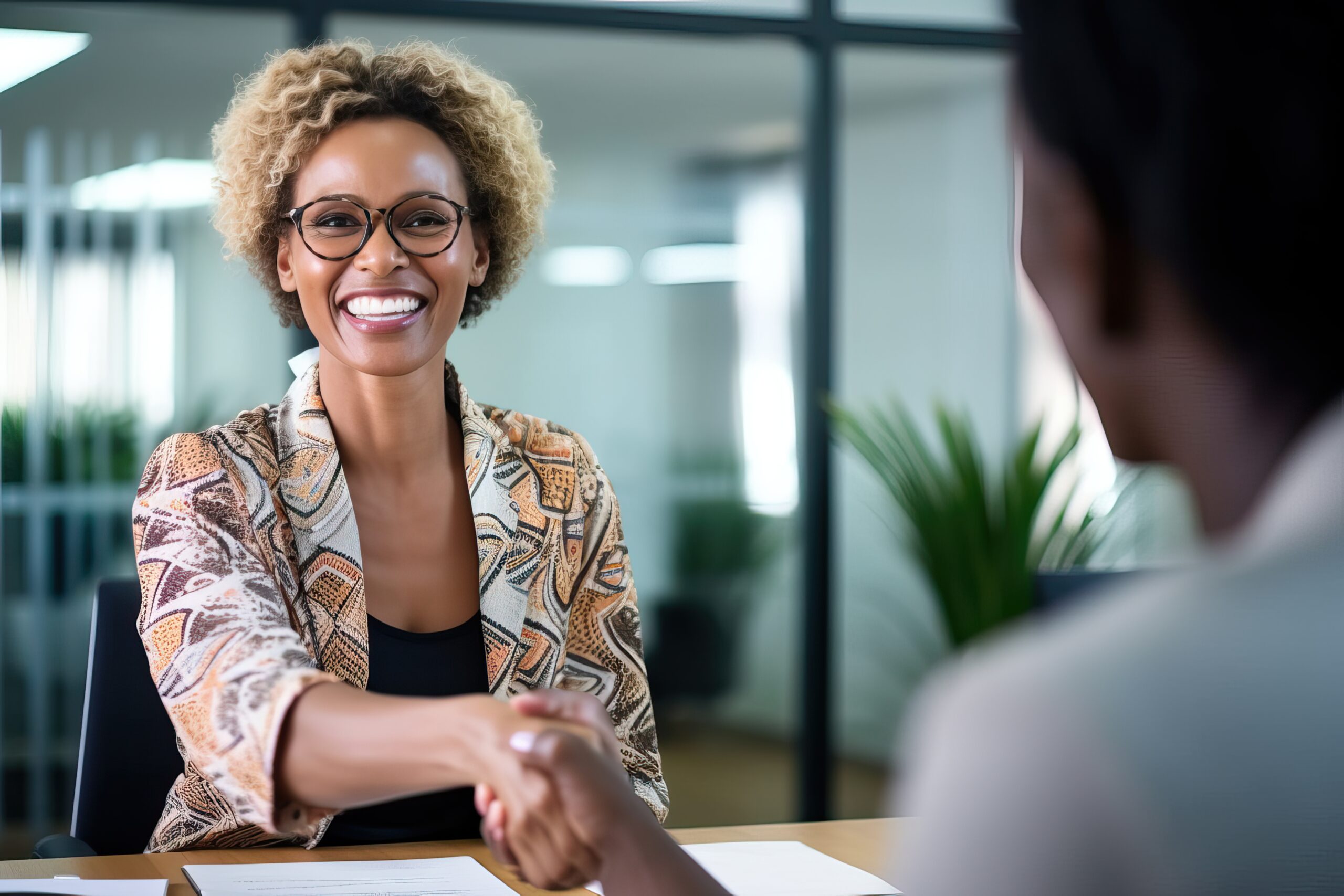 Happy business woman manager handshaking greeting client in office.